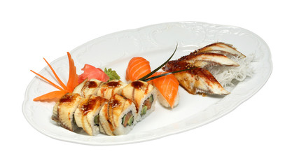 Sushi with eel and salmon, rolls with avocado, eel and salmon on white oval plate