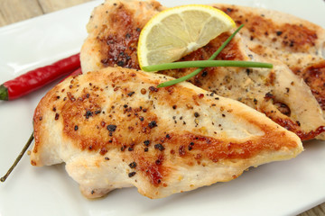 grilled chicken cutlets on a plate