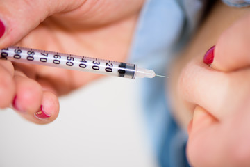 Diabetes patient insulin shot by syringe with dose of lantus, su