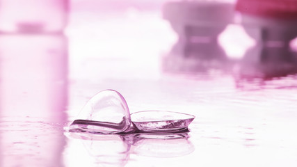 Tools for vision correction. Glasses and lenses with diopters on the background of splashes and blurry.