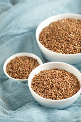 Buckwheat in a light bowl on a rustic background copy space.