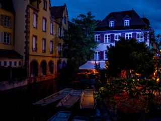 Architecture and residential buildings on the canal of the old city at night, Colmar