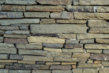old wall of stones of different sizes close-up - background