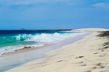 Ocean waves breaking at Cape Verde sandy beach on the island Sal