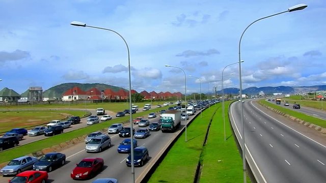 Abuja, Nigeria - 15 November 2019: Typical rush hour traffic in Nigeria. Road/Street hawkers take advantage to sell their goods.