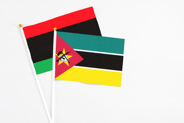 Mozambique and Libya stick flags on white background. High quality fabric, miniature national flag....