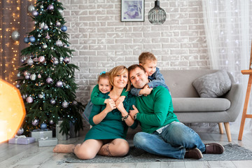 Happy family having fun together near Christmas tree