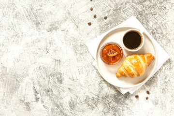 breakfast with croissants. fresh crispy croissants and coffee on a light .background, top view..