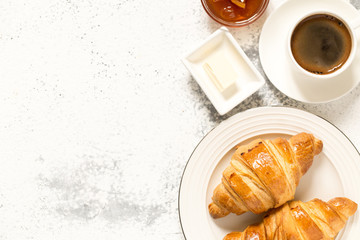 breakfast with croissants. fresh crispy croissants and coffee on a light .background, top view..