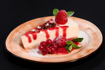 Delicious strawberry cheesecake slice and fresh berries on table close up