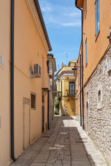 A narrow street among the old houses of a medieval town in Venosa Italy