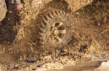 SUV wheel stalled in mud and water