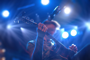 The artist plays the guitar.