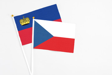 Czech Republic and Liechtenstein stick flags on white background. High quality fabric, miniature national flag. Peaceful global concept.White floor for copy space.