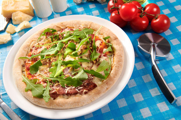 Pizza with prosciutto ham, walnuts, gorgonzola cheese and walnuts