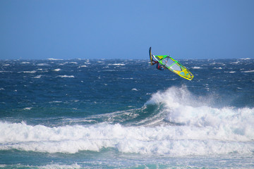 High jump of a windsurfer  in big waves of the Atlantic Ocean (El Medano, Spain)