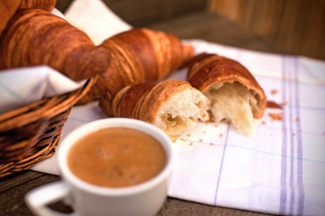 Freshly croissant and coffee for pleasure, delicious breakfast