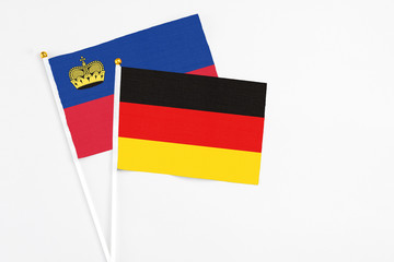 Germany and Liechtenstein stick flags on white background. High quality fabric, miniature national flag. Peaceful global concept.White floor for copy space.