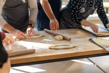 Obraz na płótnie Canvas Culinary master class. Closeup of people hands preparing khachapuri. Traditional georgian cheese bread. Georgian food