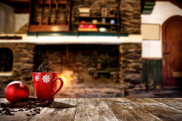 Christmas mugs with a hot drink. Steam smoke and Christmas decoration. Blurry background of a rustic fireplace with flame. American rifles on a stand. Place for your christmas gifts.Dark mood shadows.