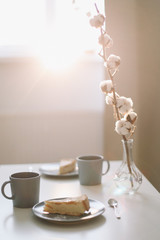 Piece of apple pie on plate with cup of coffee on white table. Breakfast with coffee and cake in cafe. food photography. 