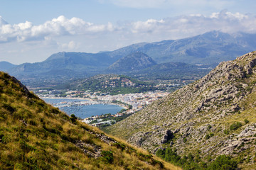 View of Port de Pollenca through Hills with Mountains in Background at Mirador Es Colomer, Mallorca, Spain 2018 - 302917839