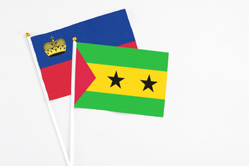 Sao Tome And Principe and Liechtenstein stick flags on white background. High quality fabric, miniature national flag. Peaceful global concept.White floor for copy space.