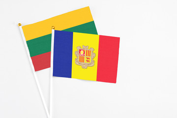 Andorra and Lithuania stick flags on white background. High quality fabric, miniature national flag. Peaceful global concept.White floor for copy space.