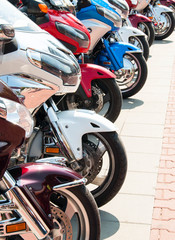 An exhibition of sports motorcycles lined up in a row on the city square
