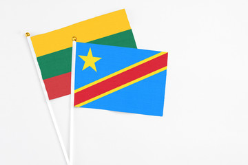 Congo and Lithuania stick flags on white background. High quality fabric, miniature national flag. Peaceful global concept.White floor for copy space.