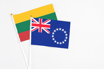 Cook Islands and Lithuania stick flags on white background. High quality fabric, miniature national flag. Peaceful global concept.White floor for copy space.