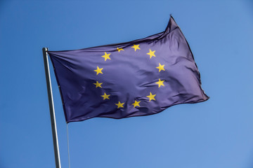 A European flag in the blue sky