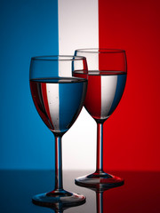 Two wine glasses silhouette full on french flag background. Alcohol beverage.