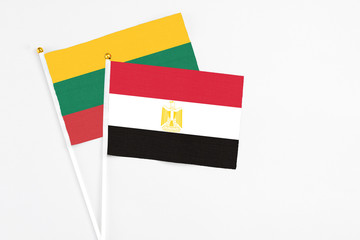 Egypt and Lithuania stick flags on white background. High quality fabric, miniature national flag. Peaceful global concept.White floor for copy space.