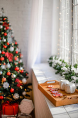 Beautiful holiday decorated room with Christmas tree with presents under it