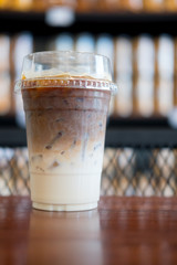 Latte iced coffee on wood table