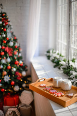 Beautiful holiday decorated room with Christmas tree with presents under it