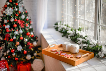 Beautiful holiday decorated room with Christmas tree with presents under it