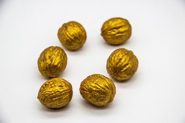 A golden walnuts on a white background