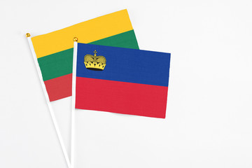Liechtenstein and Lithuania stick flags on white background. High quality fabric, miniature national flag. Peaceful global concept.White floor for copy space.