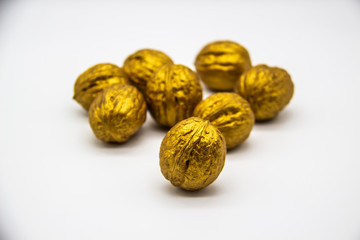 A golden walnuts on a white background