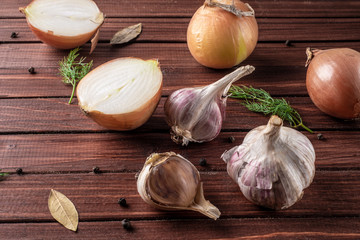 Onion and garlic with spices on a wooden table top view