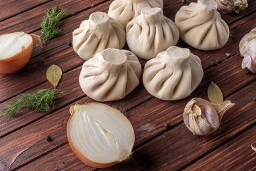 Georgian khinkali dumplings with meat, onion and garlic in the layout on the cutting Board
