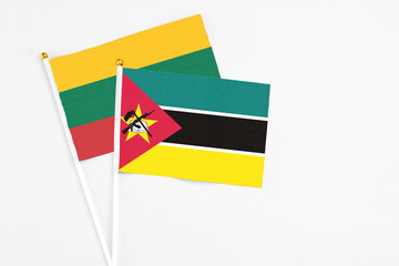 Mozambique and Lithuania stick flags on white background. High quality fabric, miniature national...