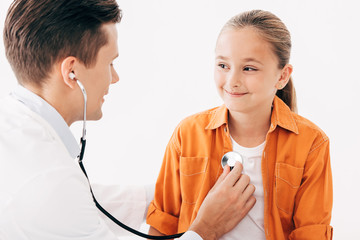 pediatrist in white coat examining kid with stethoscope isolated on white