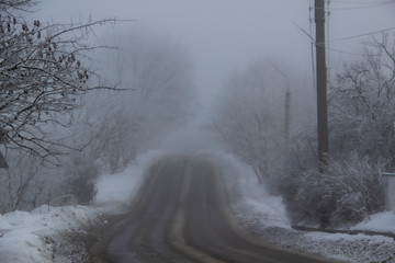 Fototapeta premium A Winter road to the fog