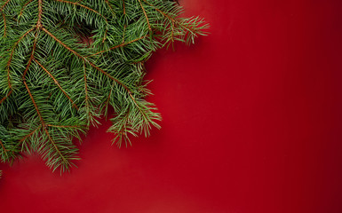 Christmas card with Christmas tree and gifts on a red background. with a place for congratulations.