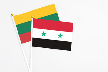 Syria and Lithuania stick flags on white background. High quality fabric, miniature national flag....
