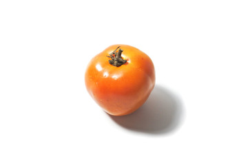 Close up center view single fresh orange tomato isolated on withe background with brown clipping. Centered single tomato isolated on white background