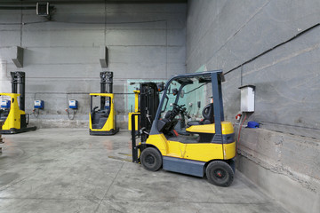 forklift charging in the warehouse © gluschenkoart